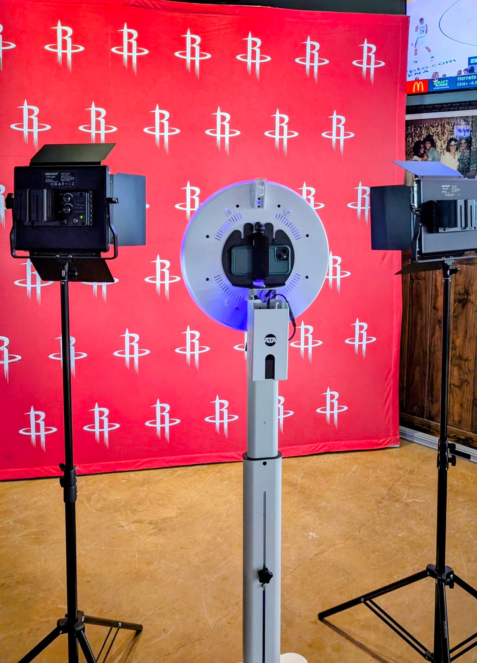 OWLShots selfie mirror booth set up in front of a Houston Rockets branded step-and-repeat